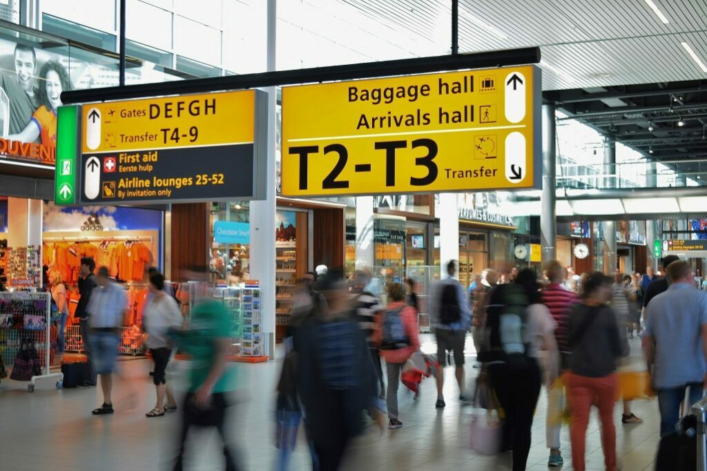 Variety of stores at the airport with yellow color signages giving directions to the visitors.