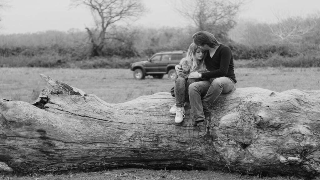 couple Sitting on Tree Log
