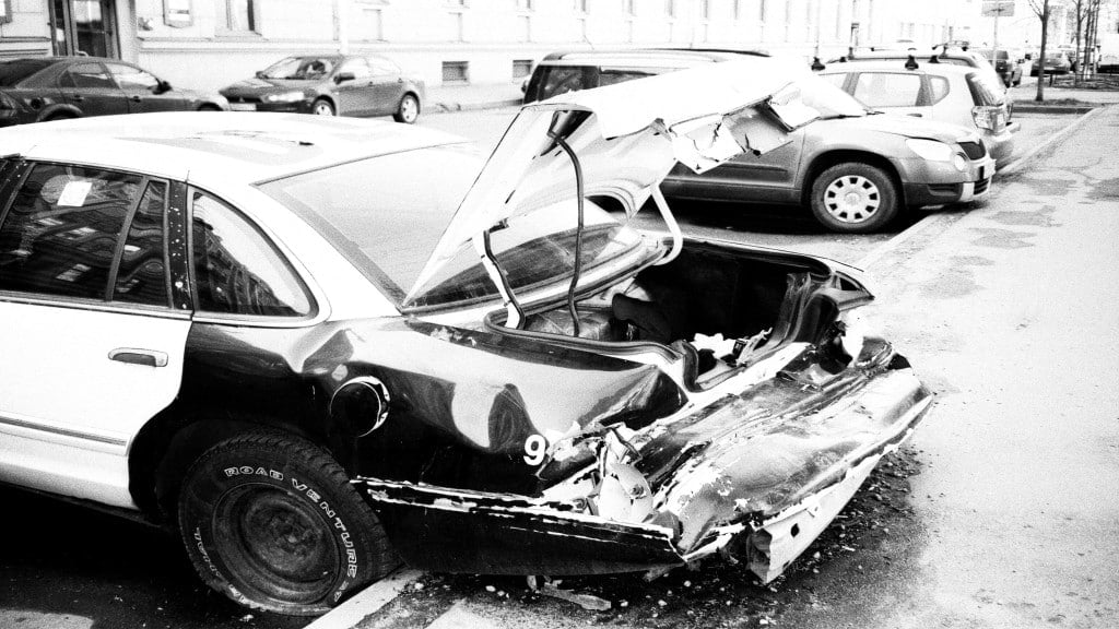 damage car in parking area with other cars