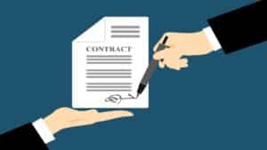 two hands showing copy of valid contract agreement